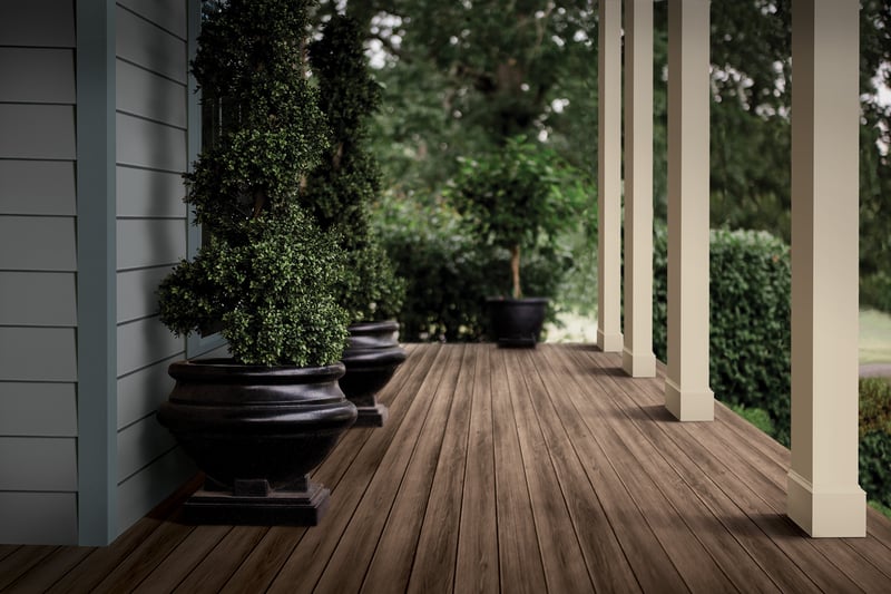 Royal Column Wraps in Sand Dune, Zuri Premium Decking in Weathered Gray; Royal Haven Insulated Siding D7 in Storm; Haven Accessories in Midnight Surf